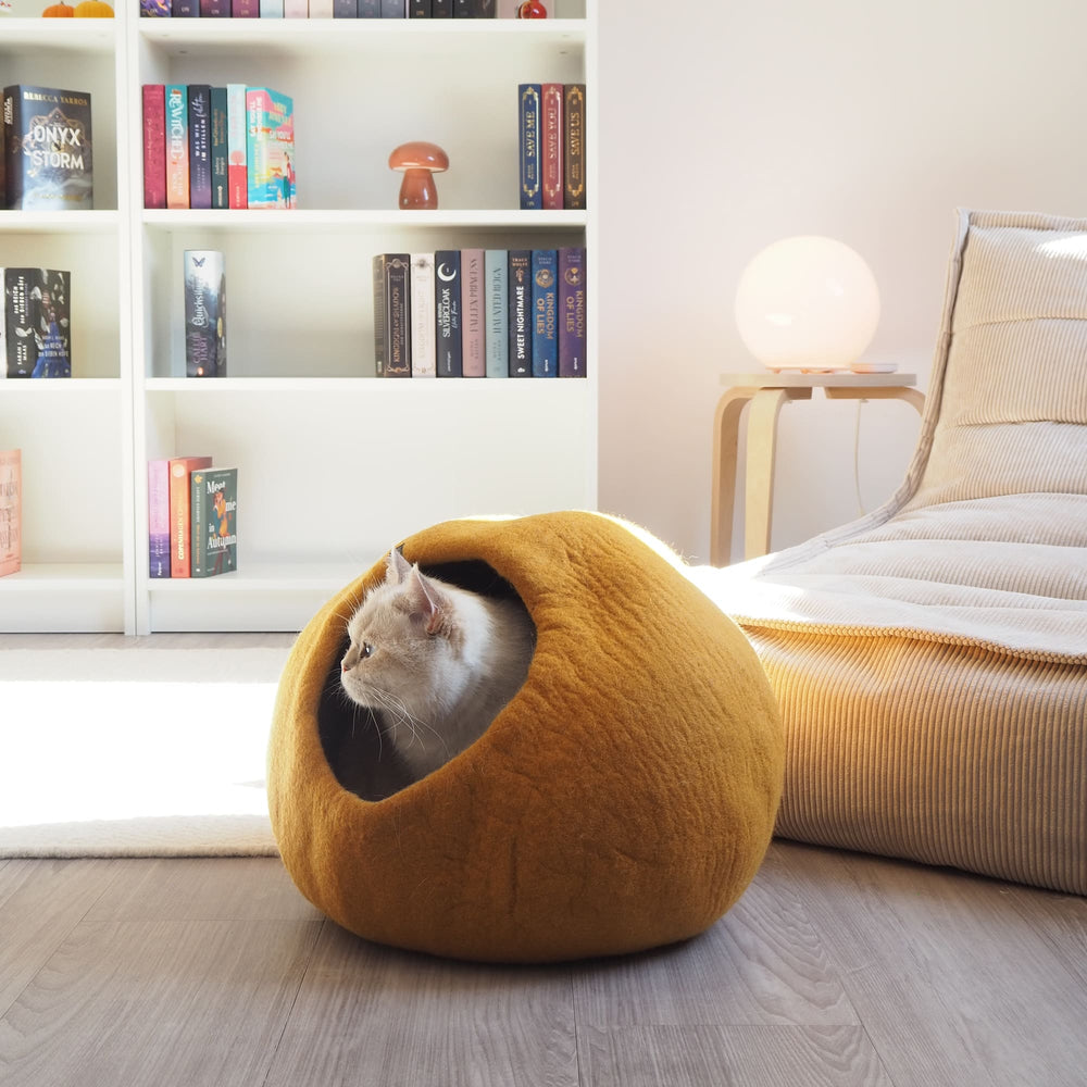 Cat inside the PEBBLE felt cat cave in mustard
