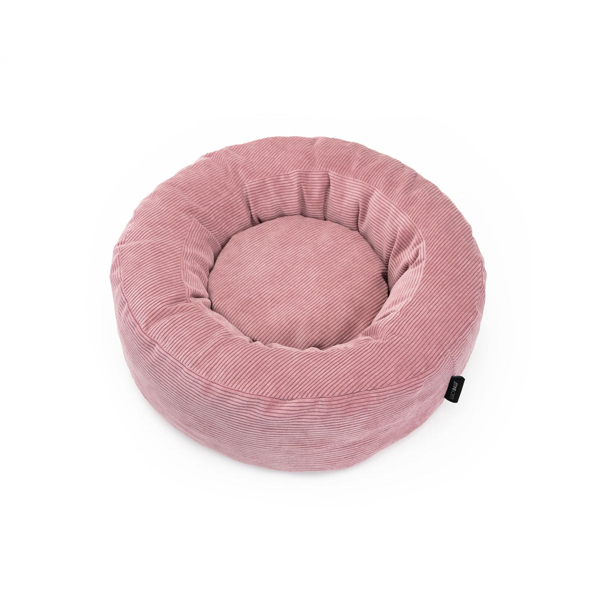 Vogelperspektive auf das runde Katzenbett aus rosa Cordstoff